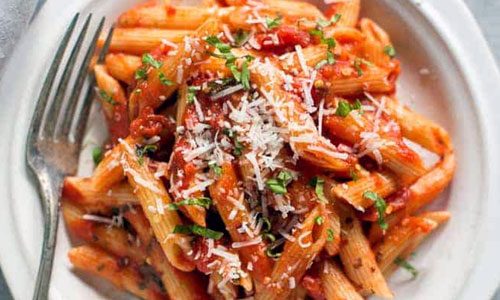 Bowl of Penne Arrabbiata pasta with tomato sauce